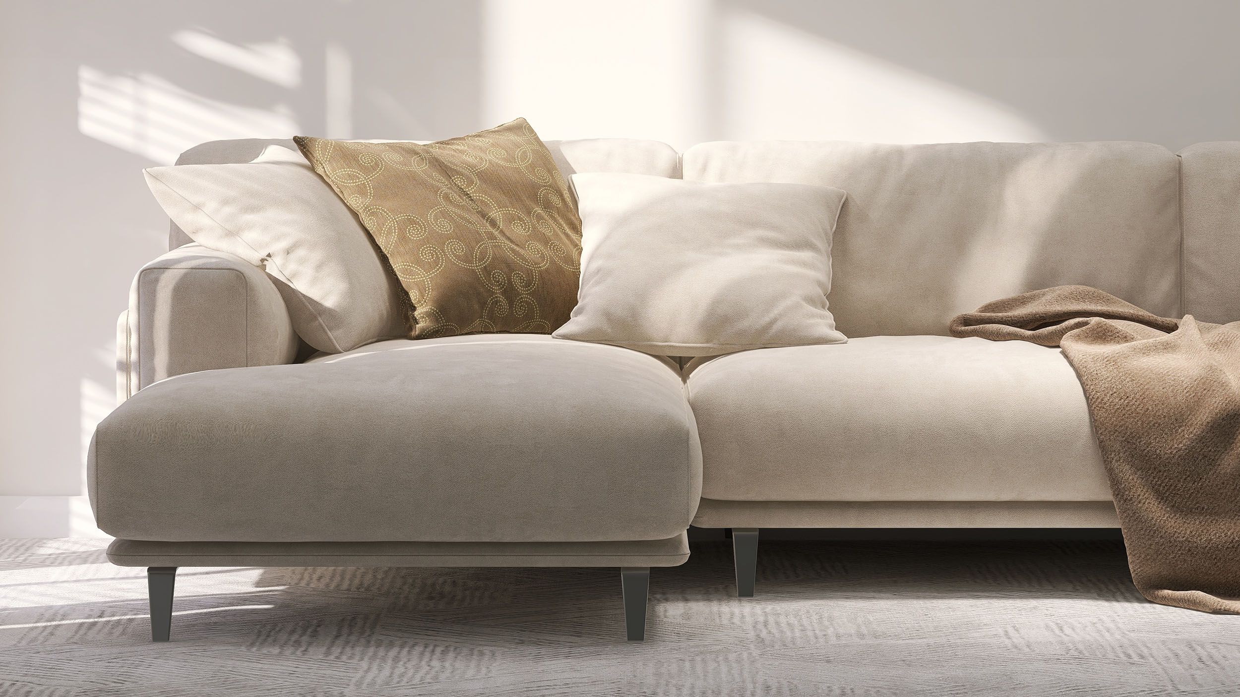 cream colored couch with pillows